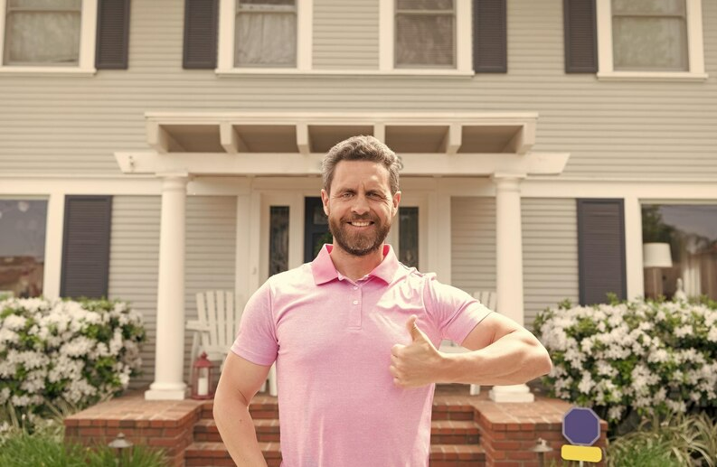Property owner in front of house
